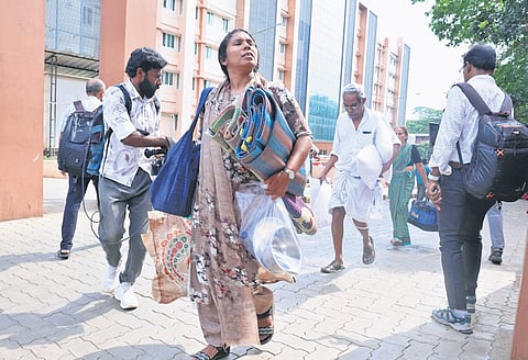 Patients and bystanders being evacuated from the super speciality block of the Kozhikode Medical College Hospital when smoke emanated from the sixth floor of the hospital on Monday.