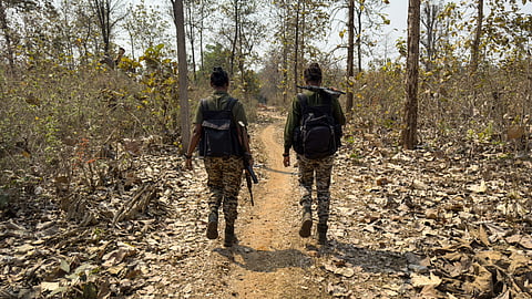 This photograph taken on March 16, 2025, shows District Reserve Guard (DRG) personnel Sanjana Yadav (R) and Anjila Minj patrolling during a simulation exercise at their base in Dantewada, in Bastar division of India's Chhattisgarh state.