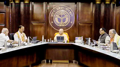 Uttar Pradesh Chief Minister Yogi Adityanath chairs a cabinet meeting, at Lok Bhawan in Lucknow on Tuesday. 