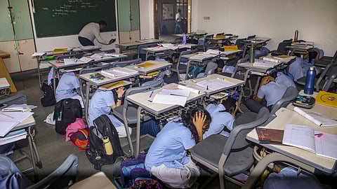  School students take part in a drill as part of a nationwide civil defence drill, in Noida, Wednesday, May 7, 2025. 