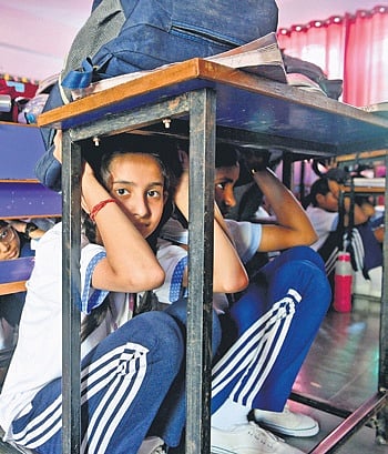 The drill commenced with the sounding of a siren, prompting students to immediately switch off all electrical appliances and take cover under their desks or near walls.