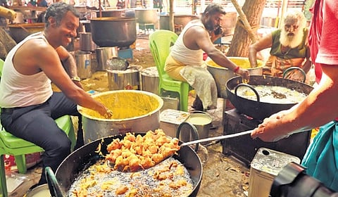 Volunteers helping to prepare food for the grand feast, at Sethupathi school in Madurai on Wednesday