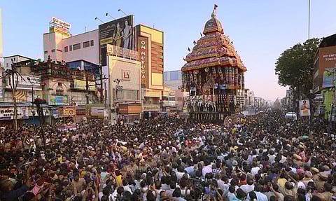 Devotees are seen pulling the massive car during the Chithirai festival of Madurai