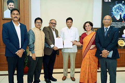 TCS Ion representative Smriti Mulye, JNTU VC Kishan Kumar Reddy, TCS Ion Global Head Venguswamy, and IT advisor Sai Krishna exchanging agreement documents in the presence of Minister Sridhar Babu.