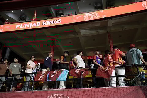 Spectators leave the stands after the authorities asked to evacuate the stadium during the Indian Premier League match between Punjab Kings and Delhi Capitals in Dharamsala (Photo | AP)