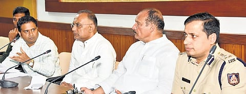 Minister Dinesh Gundu Rao (3rd from right) meets officials in Mangaluru on Saturday.