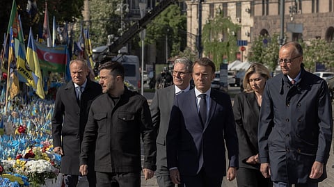 Poland's Prime Minister Donald Tusk, Ukraine's President Volodymyr Zelensky, Britain's Prime Minister Keir Starmer, France's President Emmanuel Macron, Olena Zelenska and Germany's Chancellor Friedrich Merz pay their respects to the victims of war at the Memorial for the Fallen at the Independence Square (Maidan) in Kyiv on May 10, 2025, ahead of a gathering of European leaders in the Ukranian capital. The leaders of Britain, France, Germany and Poland make an unprecedented joint visit to Kyiv on May 10, 2025 for talks with Ukraine's President Volodymyr and to urge Russia to agree a ceasefire, a joint statement said.