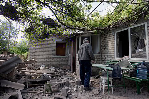 A local resident looks at a damaged private house after Russian shelling in Kramatorsk, Donetsk region on May 11, 2025, amid the Russian invasion of Ukraine. 