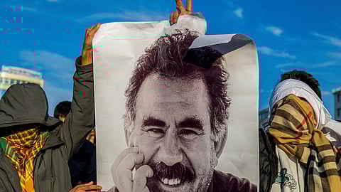 Youngsters hold a photograph of the jailed leader of the rebel Kurdistan Workers' Party, or PKK, Abdullah Ocalan. 