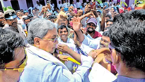 Chief Minister Siddaramaiah interacts with supporters in HD Kote of Mysuru district on Monday 