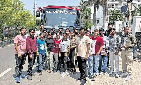 The students who were evacuated from Srinagar and Ganderbal in J&K pose near their bus at a stop