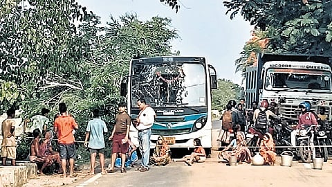 Villagers blocking the road with pots and buckets at Sasinipada on Tuesday.