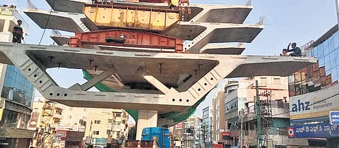 Precast girders being lifted to make the flyover in Ejipura 