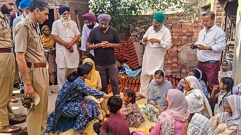 Deputy Commissioner Sakshi Sawhney meets family members of a hooch tragedy victim at Majitha in Amritsar district, Tuesday, May 13, 2025. At least 14 people have died in five villages in Punjab's Amritsar after allegedly consuming spurious liquor. 