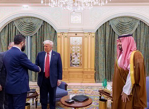 Saudi Crown Prince Mohammed bin Salman (R) watching as US President Donald Trump (C) shakes hands with Syria's interim president Ahmed al-Sharaa in Riyadh (Photo | AFP)
