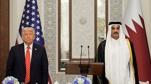 US President Donald Trump and Qatar's Emir Sheikh Tamim bin Hamad Al Thani stand during the US national anthem at a state dinner at Lusail Palace in Doha, Qatar, Wednesday, May 14, 2025.