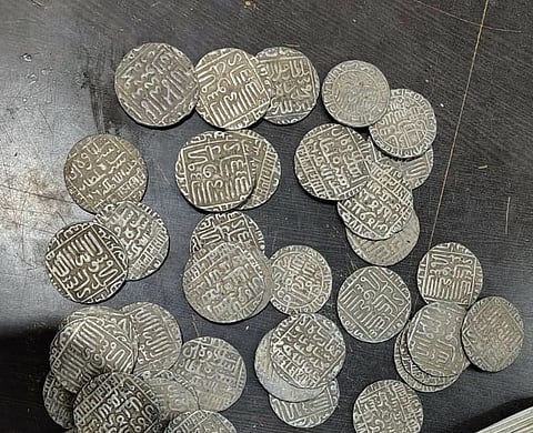 51 silver coins and two gold coins were seized from the labourers (Photo | Special arrangement)