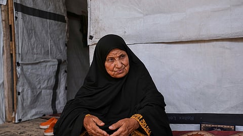 Ghalia Abu Moteir, whose family fled what is now Israel during the 1948 war that surrounded its creation, shelters from the current war in a tent in Khan Younis, Gaza Strip, after being displaced from her home in Rafah, Wednesday, May 14, 2025.