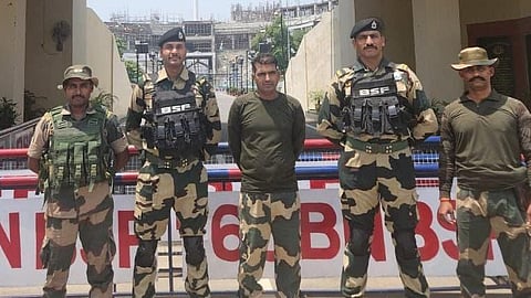 BSF Constable PK Shaw (centre) handed over to BSF at the Attari border