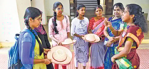 E L Prathee Jeen, a former teacher, gifting handmade palm-leaf hats to students at the TAN Palm Foundation, established by her in Kanniyakumari