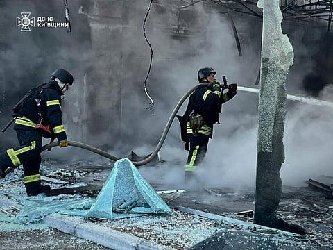 In this photo provided by the Ukrainian Emergency Service, firefighters put out the fire following Russia's drone attack in the Kyiv region, Ukraine, Sunday, May 18, 2025.