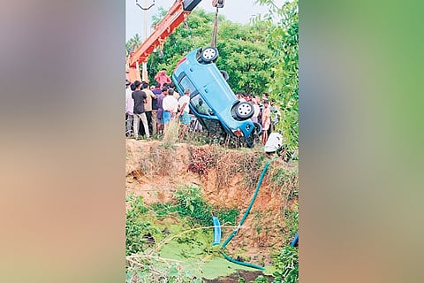 Police and locals retrieving the car from an agriculture well in Annamayya district on Sunday