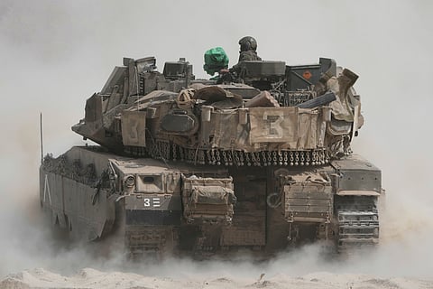 Israeli soldiers move tanks around staging area near the border with the Gaza Strip, in southern Israel, Sunday, May 18, 2025. 