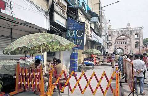 Police on Monday guard the building gutted in the fire 