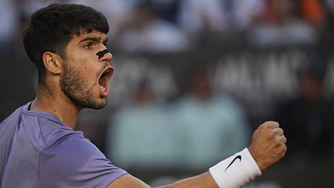 Carlos Alcaraz of Spain, reacts after scoring a point against Jannik Sinner of Italy during their final tennis match in the Italian Open at the Foro Italico in Rome, Sunday, May 18, 2025.