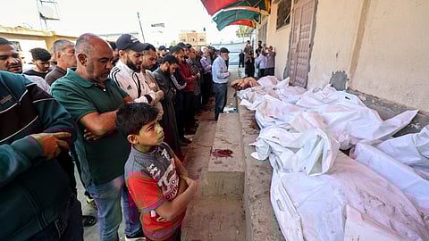 Mourners pray over the bodies of Palestinians killed in Israeli strikes, at the al-Aqsa Martyrs hospital in Deir el-Balah in the central Gaza Strip on May 20, 2025.