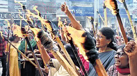 Asha workers take out a torchlight march to mark the 100th day of their protest in front of the Secretariat on Tuesday