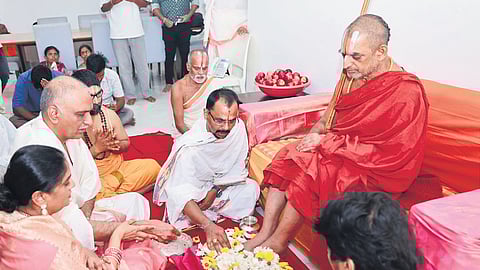 Former minister and BRS MLA T Harish Rao performs pada puja to Chinna Jeeyar Swamy at his camp office in Sangareddy on Tuesday.