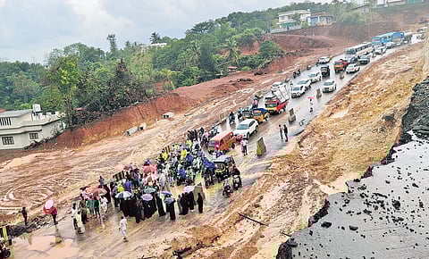 Residents stage protest following landslips at the NH construction site at Kuppam in Taliparamba, Kannur, on Wednesday