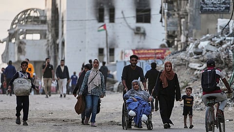 Palestinians evacuate after the Israeli army issued an evacuation warning for several schools and a hospital in Gaza City's Rimal neighborhood, Wednesday, May 14, 2025