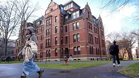 People walk between buildings, Dec. 17, 2024, on the campus of Harvard University in Cambridge, Mass. 