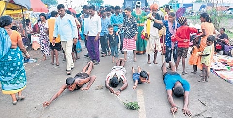 Devotees prostrate at the Dandina Durgamma fair.