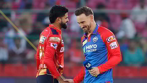Delhi Capitals' captain Faf du Plessis, right, shakes hands with Punjab Kings' captain Shreyas Iyer before the start of the Indian Premier League cricket match between Punjab Kings and Delhi Capitals at Sawai Mansingh Stadium in Jaipur