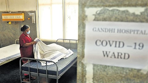 A worker arranges beds in a newly prepared COVID-19 ward at Gandhi Hospital in Secunderabad on Saturday 