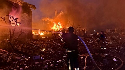 In this photo provided by the Ukrainian Emergency Service, firefighters try to put out a fire following a Russian attack in Kyiv region, Ukraine, Sunday, May 25, 2025.