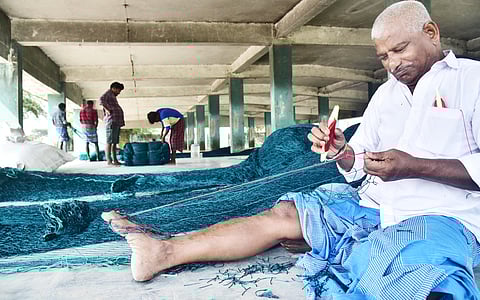 During the ban, some fishermen tend to the boats and nets
