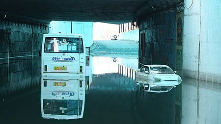 A bus and a car are submerged in water in the Delhi Cantt area after heavy rains caused severe waterlogging in several parts of the National Capital