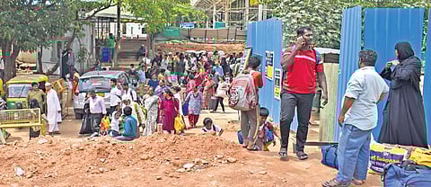 Passengers make their way through construction materials and debris at Cantonment Railway Station, in Bengaluru on Sunday.