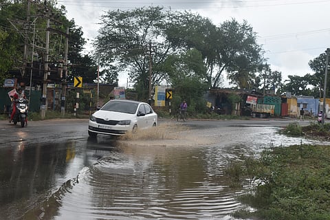 Following rain fall in last night, Motorists wading through stagnated rainwater near Pachapalayam on Siruvani main road in Coimbatore district on Sunday.