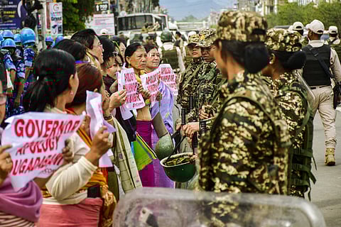 Women stage a protest demanding an apology from Manipur Governor Ajay Kumar Bhalla over the alleged removal of 'Manipur' signage from a state government bus, in Imphal, Monday, May 26, 2025.