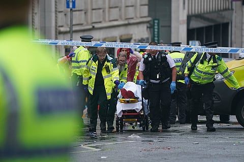 Police and emergency personnel deal with an incident near the Liver Building during the Premier League winners parade, in Liverpool, England, Monday May 26, 2025.