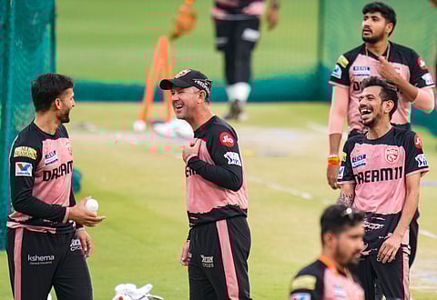 Punjab Kings head coach Ricky Ponting (C) shares a light moment with the players on the eve of their match against Royal Challengers Bengaluru