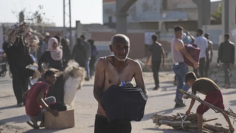 Palestinians carry boxes containing food and humanitarian aid packages delivered by the Gaza Humanitarian Foundation, a US-backed organisation approved by Israel, in Rafah, southern Gaza Strip on Tuesday, May 27, 2025. 