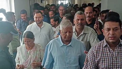 Rashtriya Janata Dal chief Lalu Prasad Yadav, his wife and son Tejashwi Yadav leave the Rouse Avenue Court in Delhi.