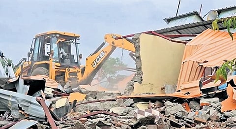 A bulldozer razes self-proclaimed seer Hathyogi Lokeshwar Swami’s illegal Ram Mandir Mutt in Mekhali village, on Thursday.