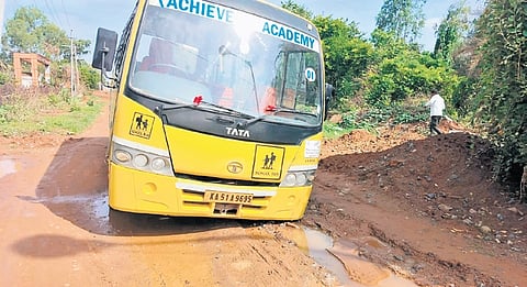 A bus gets stuck on a slushy road at Bande Nallasandra in Jigani.